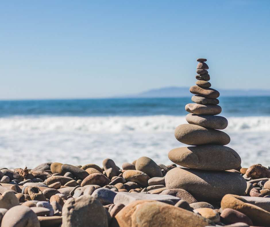 balancing stones on the beach