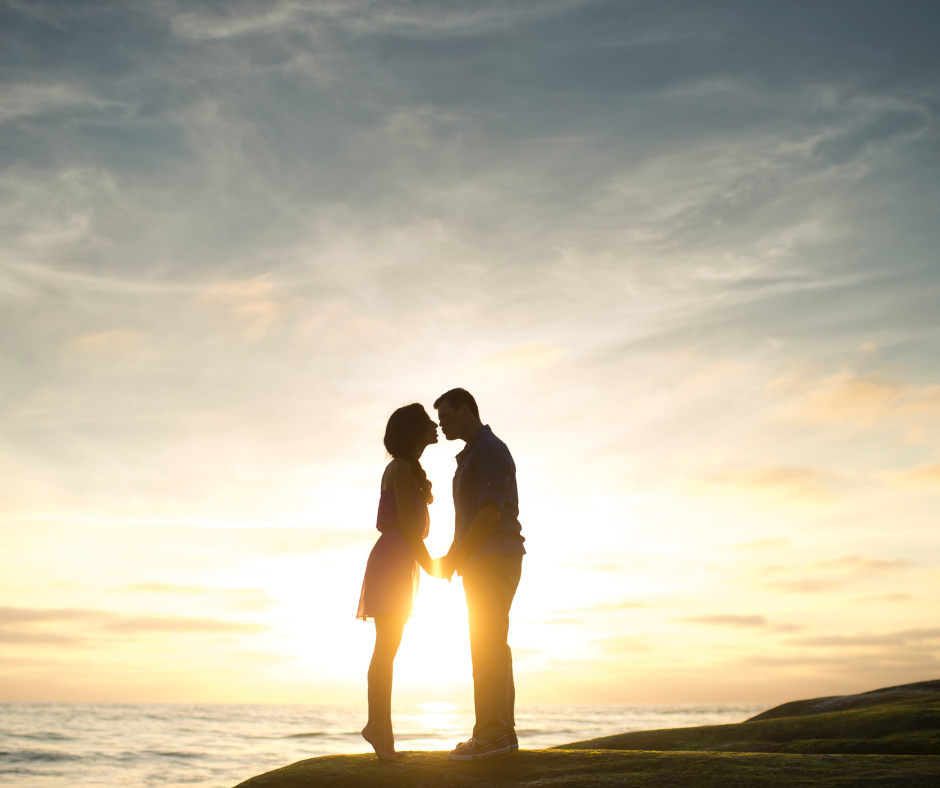 Couple looking at each other in the sunset