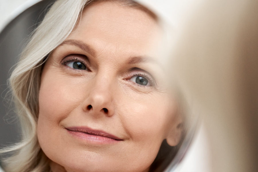 woman looking at her reflection in the mirror