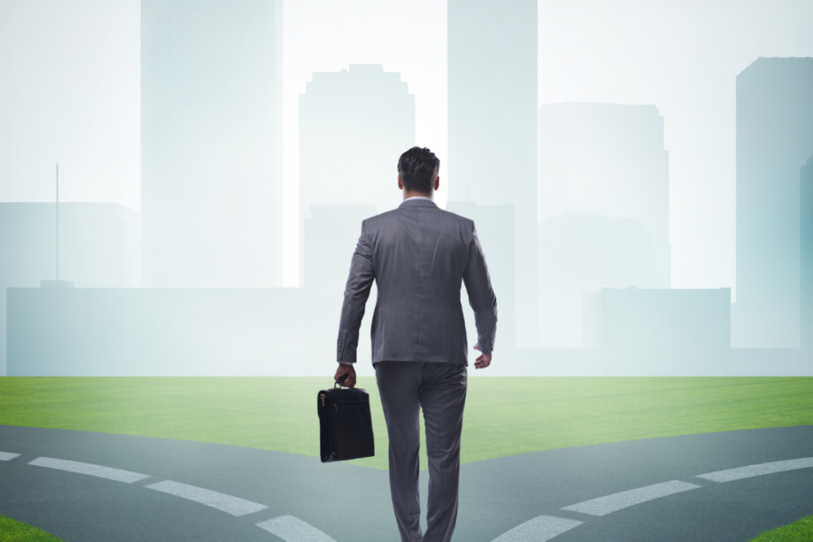 business man walking down a road that has to make a choice