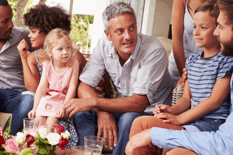 A small group of people of different ages taking the time to enjoying intimate associate at a small home gathering