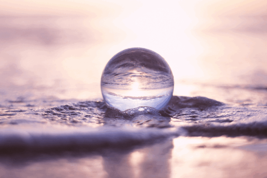 A glass marble in the water changing the direction of the water