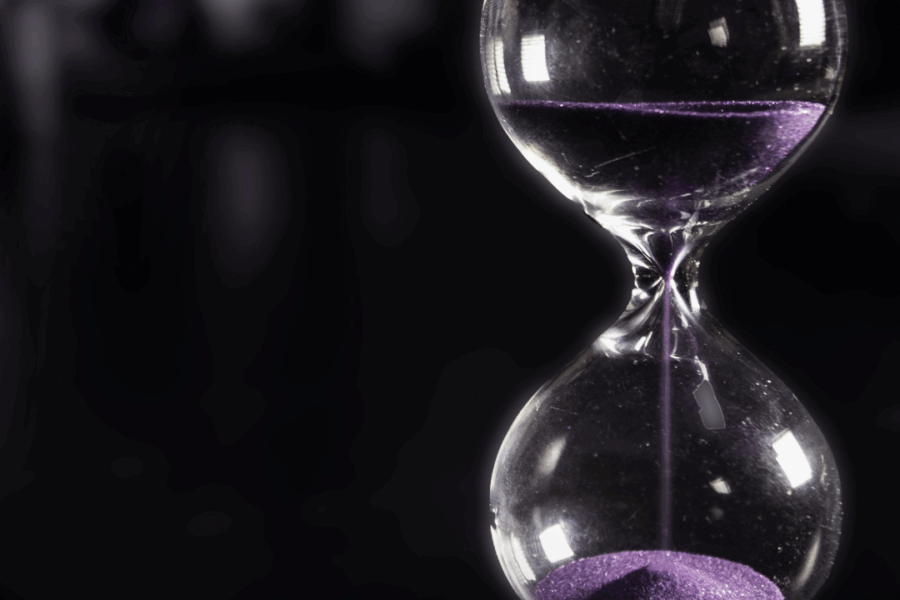 sand moving through an hourglass tracking time